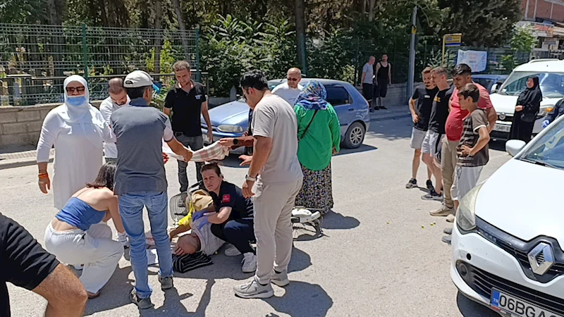 Otomobilin çarptığı bisikletliyi örtü tutarak güneşten korudular